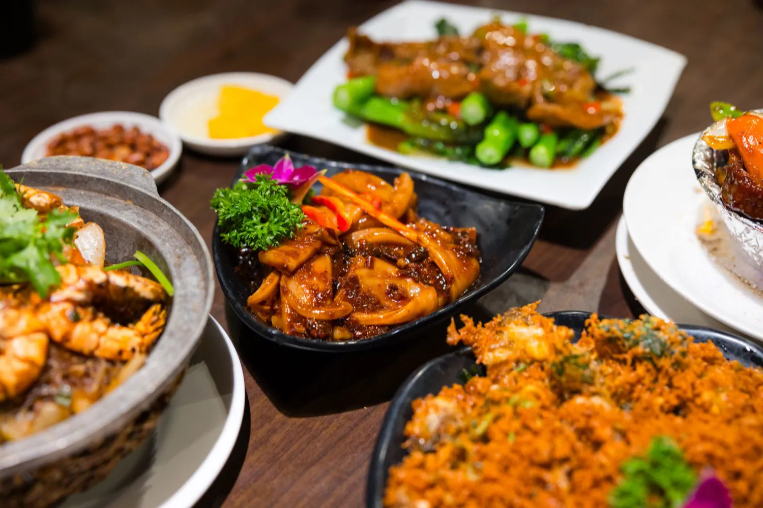 Assorted Cantonese stir-fry dishes including squid, shrimp clay pot and fried seafood at Smile House Cafe, a Hong Kong Style Fast Food Restaurant in San Francisco