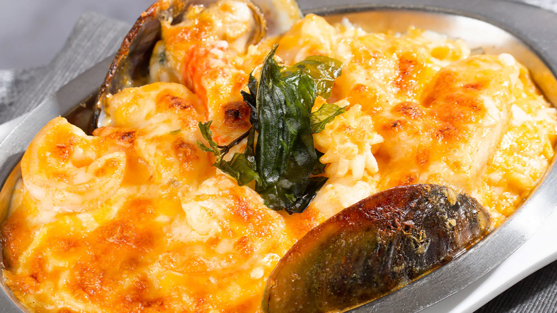 Baked seafood covered in rich cheesy cream sauce at Smile House Cafe, a Hong Kong Style Fast Food Restaurant in San Francisco