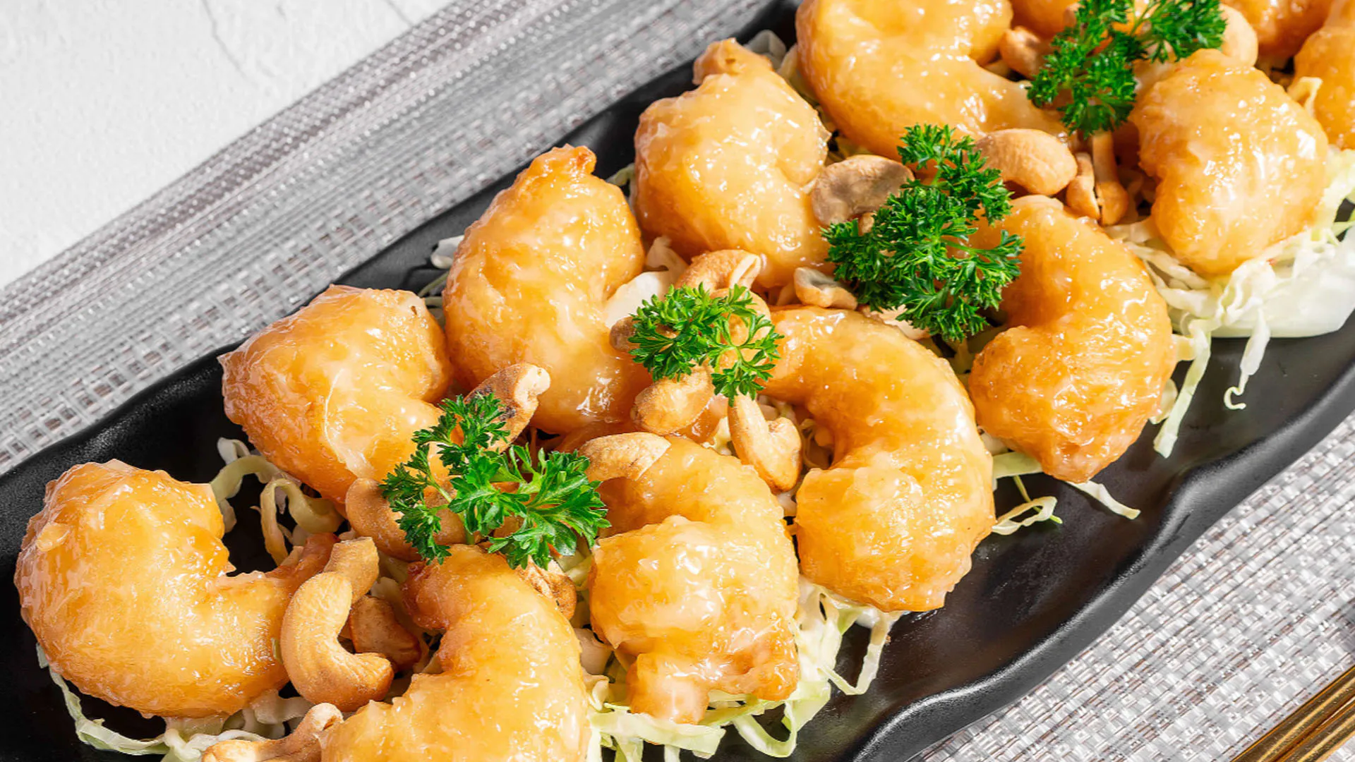 Crispy cashew fried shrimp served over shredded cabbage at Smile House Cafe, a Hong Kong Style Fast Food Restaurant in San Francisco