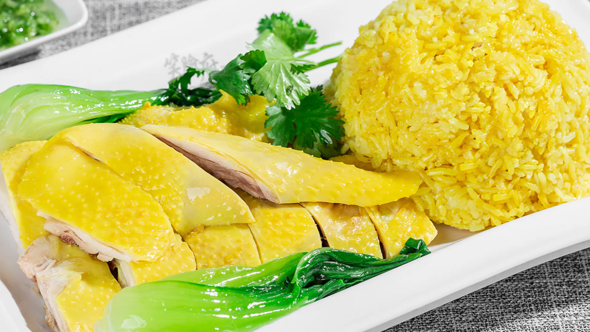 Hainanese poached chicken set with turmeric rice and bok choy at Smile House Cafe, a Hong Kong Style Fast Food Restaurant in San Francisco