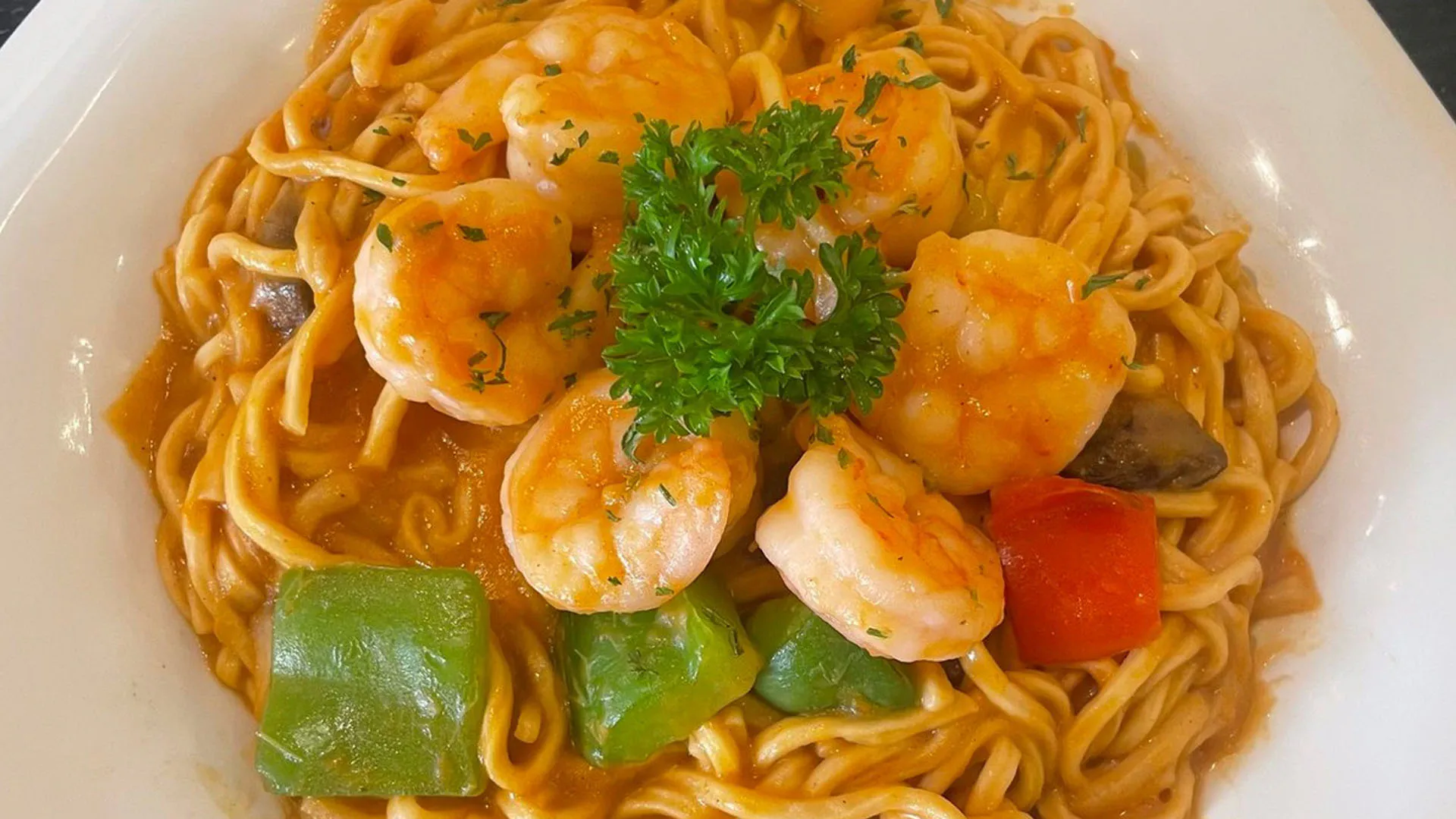 Spicy tomato prawn spaghetti mixed with bell pepper chunks at Smile House Cafe, a Hong Kong Style Fast Food Restaurant in San Francisco