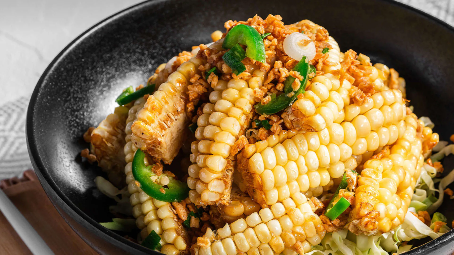 Salt and pepper baby corn stir fry with green chili slices at Smile House Cafe, a Hong Kong Style Fast Food Restaurant in San Francisco