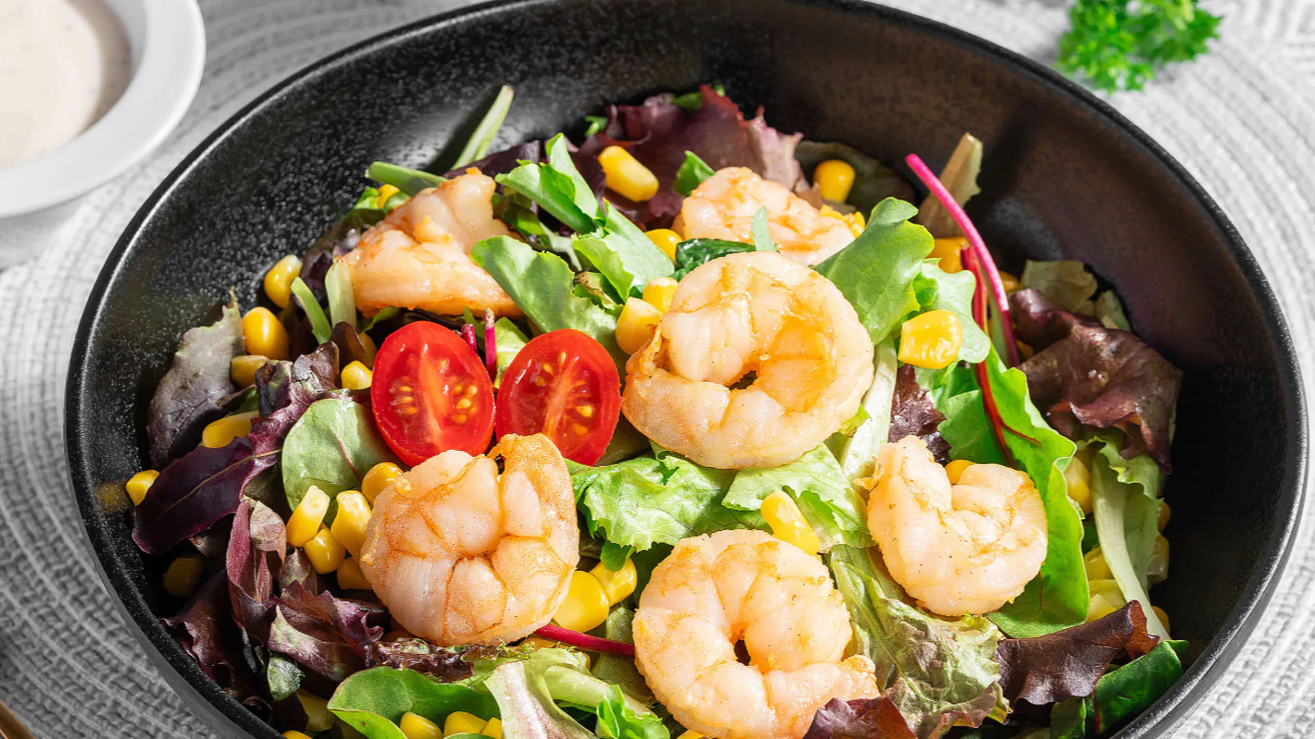 Fresh garden shrimp salad mixed with cherry tomatoes and leafy greens at Smile House Cafe, a Hong Kong Style Fast Food Restaurant in San Francisco