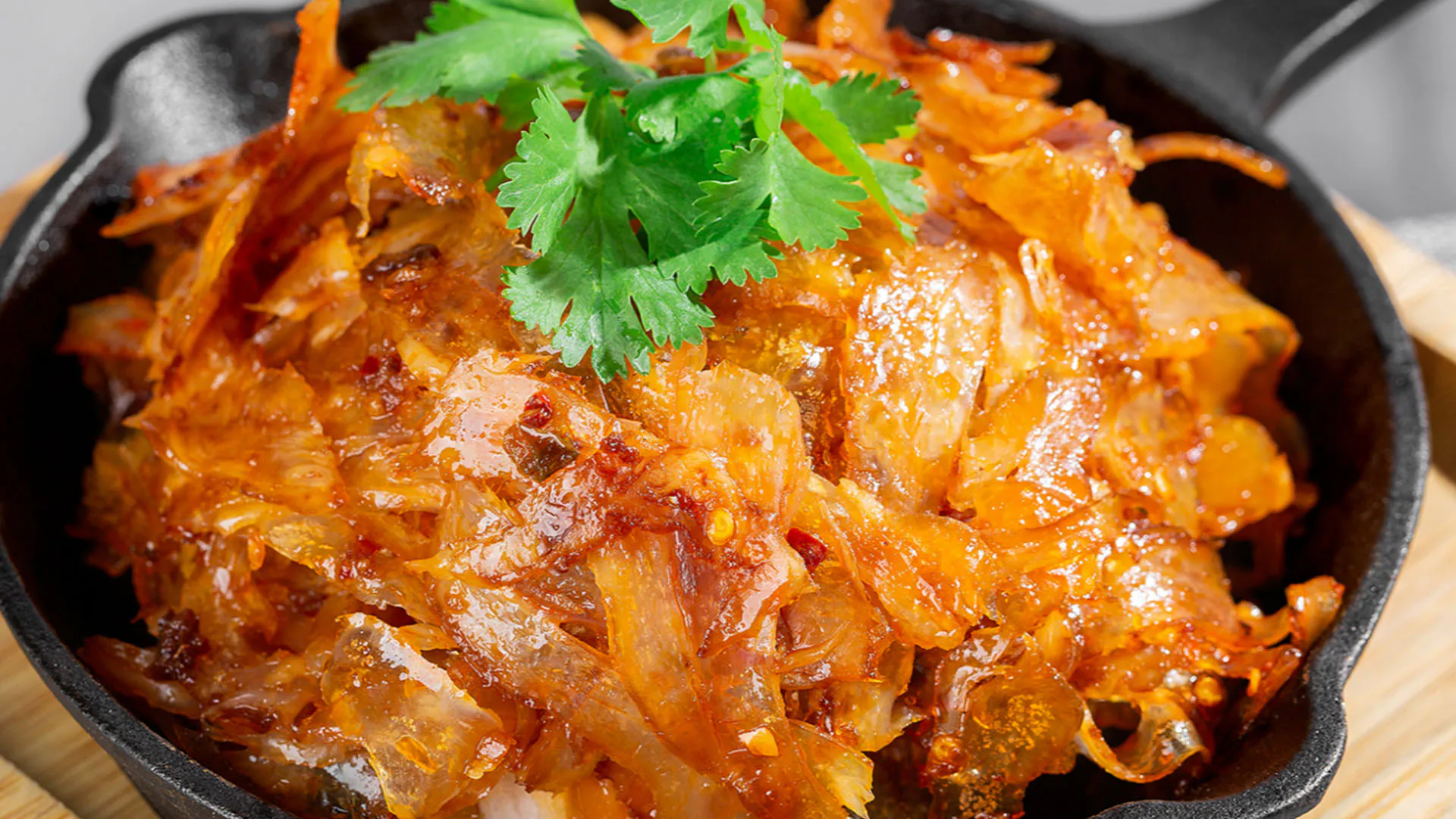 Spicy braised beef tendon stir fry garnished with fresh cilantro at Smile House Cafe, a Hong Kong Style Fast Food Restaurant in San Francisco